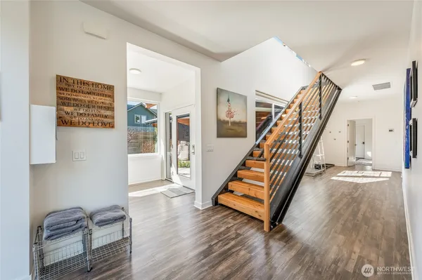 a view of entryway and hall with wooden floor