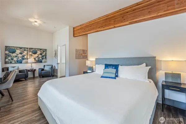 a large bed sitting in a bedroom and a table