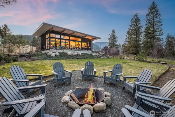an outdoor sitting area with furniture and garden view