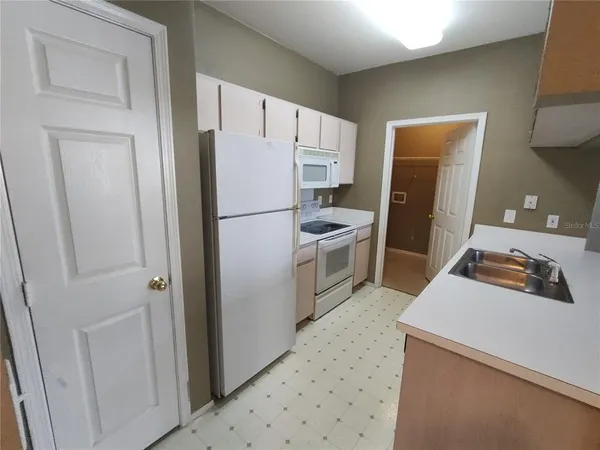 a kitchen with a sink cabinets and window
