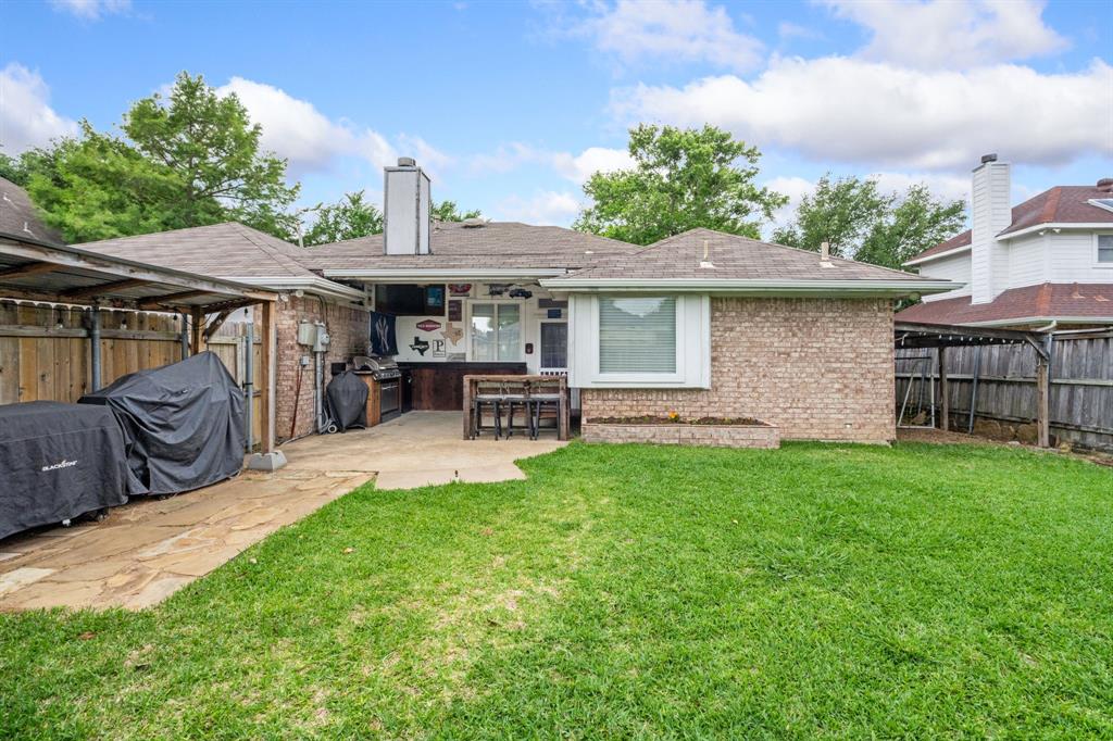 2302 Randi Road Rowlett, TX 75088 - Photo 26 of 33 a view of a backyard with table and chairs potted plants and a palm tree