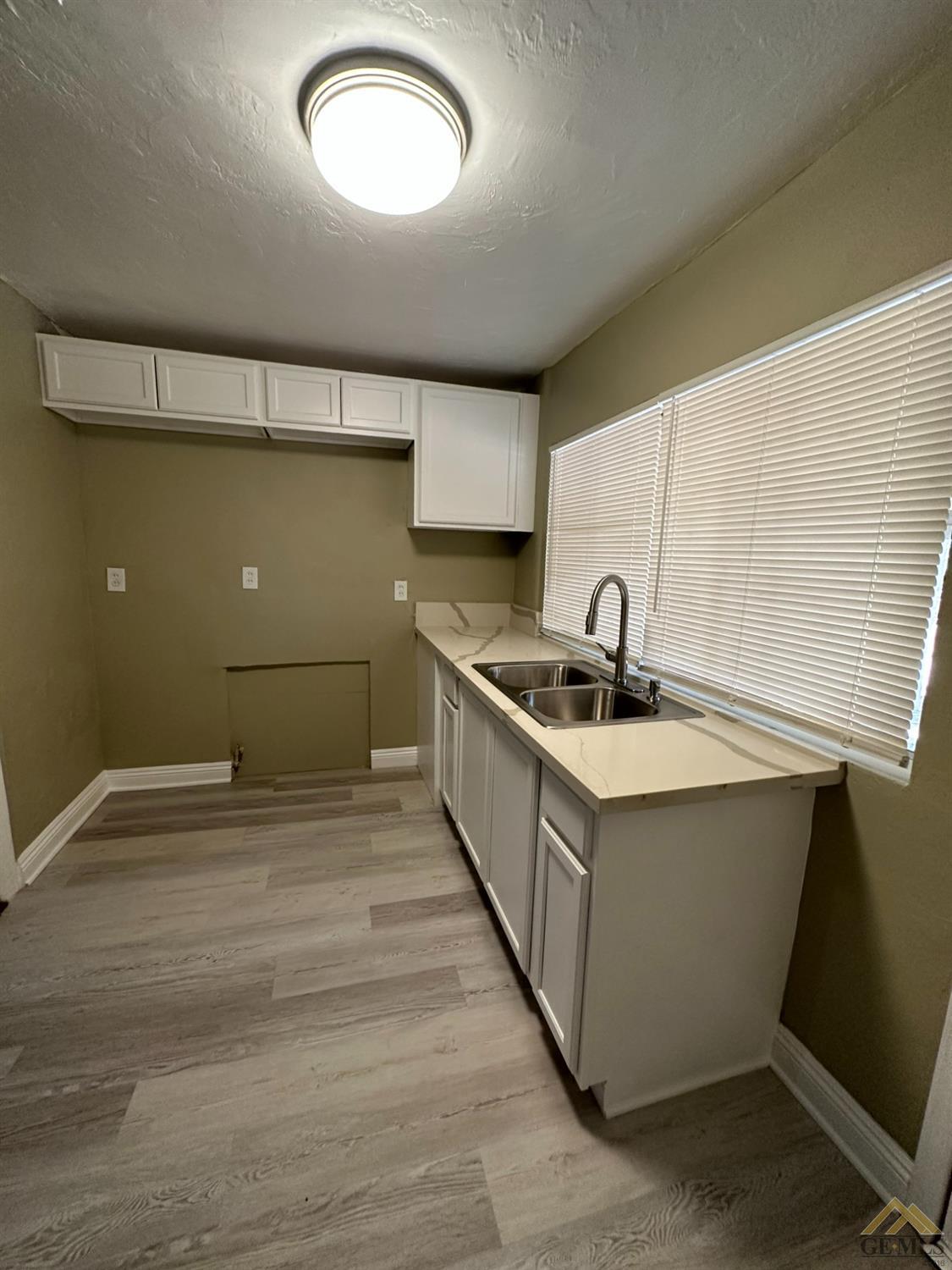 Undisclosed Address Bakersfield, CA 93306 - Photo 3 of 15 a kitchen with stainless steel appliances granite countertop a sink and a stove