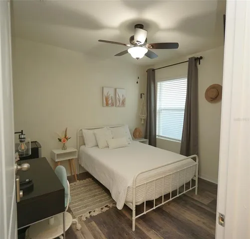 a bedroom with a bed and a chandelier