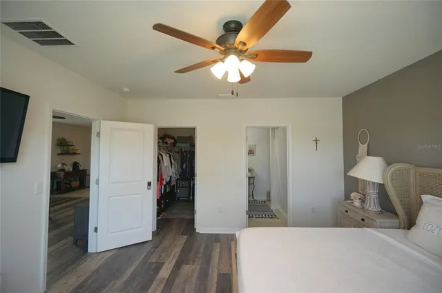 a bedroom with a bed and a chandelier