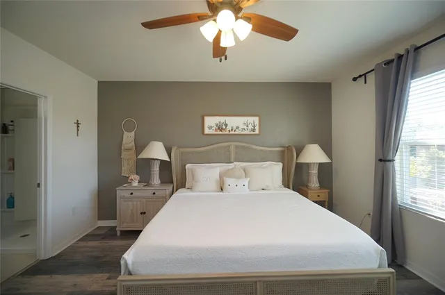 a bedroom with a bed and a chandelier