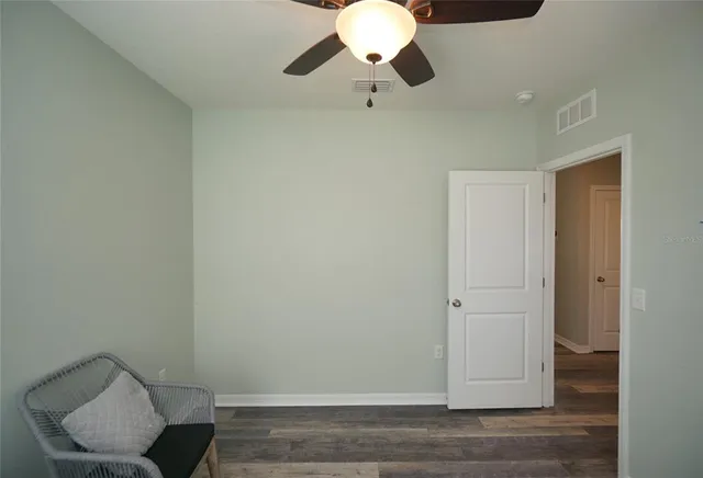 a view of room with a potted plant and wooden floor