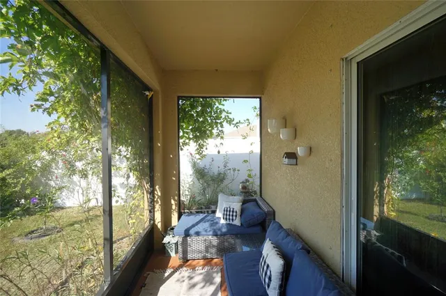 a balcony view with a large window and sitting area
