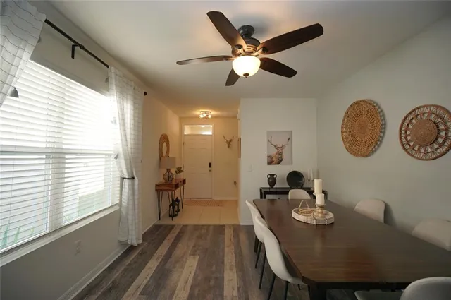 a view of a dining room with furniture window and wooden floor
