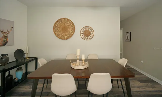a view of a dining room with furniture and wooden floor