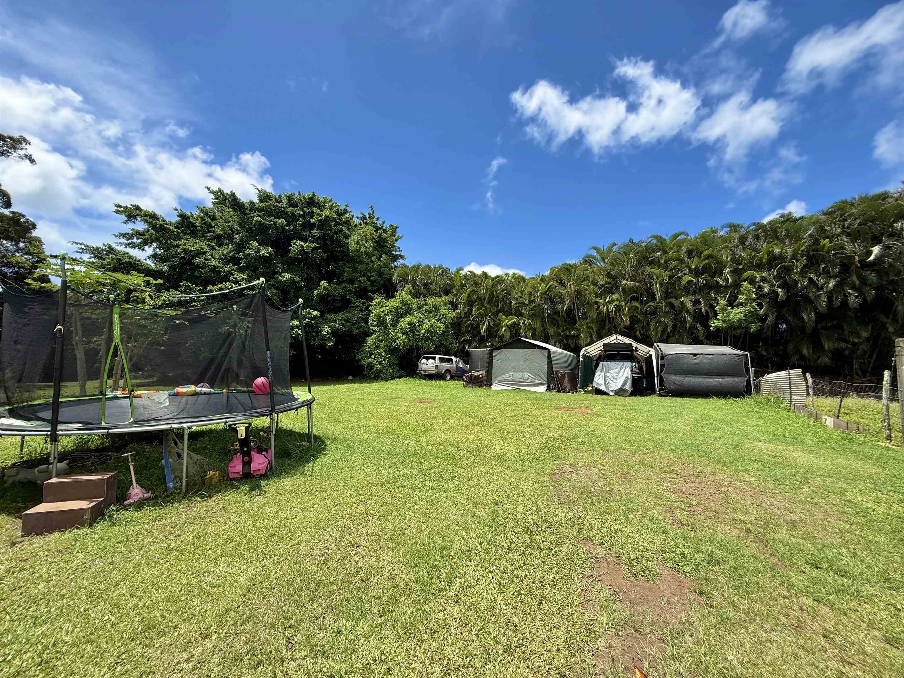 1630 Kauhikoa Road Haiku, HI 96708 - Photo 37 of 48 a backyard of a house with table and chairs