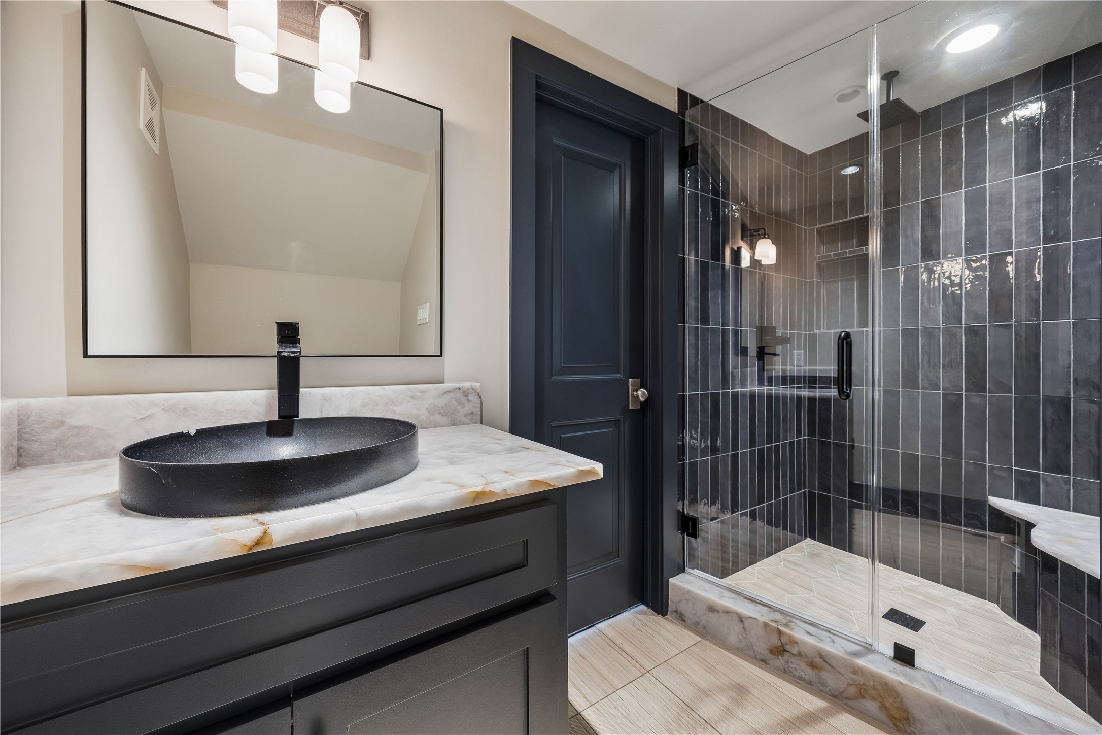 926 Nicholson Street Houston, TX 77008 - Photo 18 of 39 A beautifully refreshed main-level bath offers both convenience and sophistication, highlighted by its spacious walk-in shower.