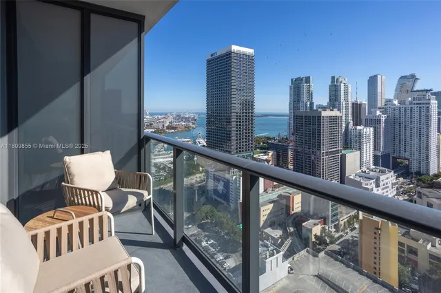 a spacious bedroom with a bed and a chandelier