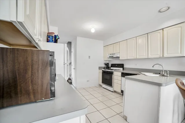 a kitchen with a stove a sink and a refrigerator
