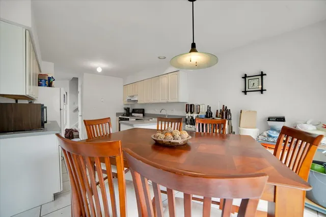 a dining room with furniture and a chandelier