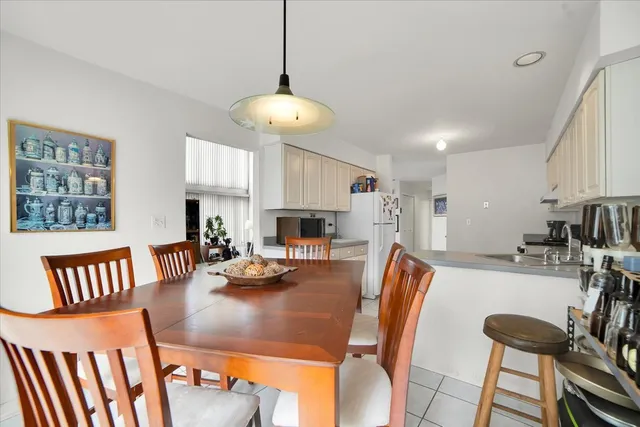 a view of a dining room with furniture and a chandelier