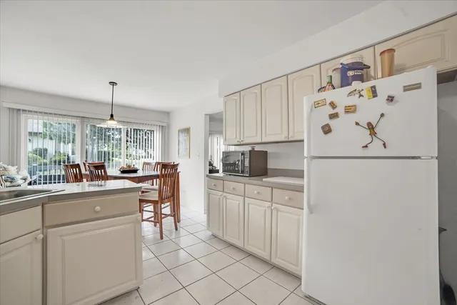 a kitchen with white cabinets and white appliances