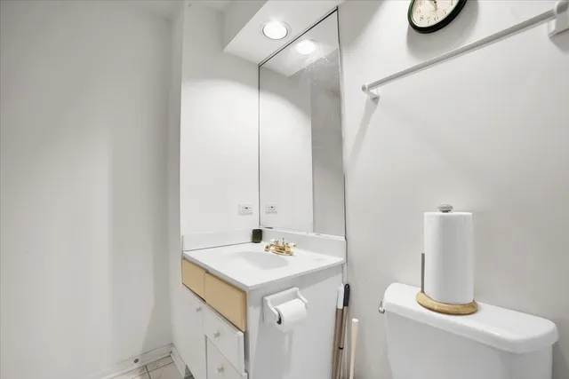 a bathroom with a sink vanity and a mirror