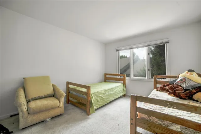 a bedroom with furniture and a window