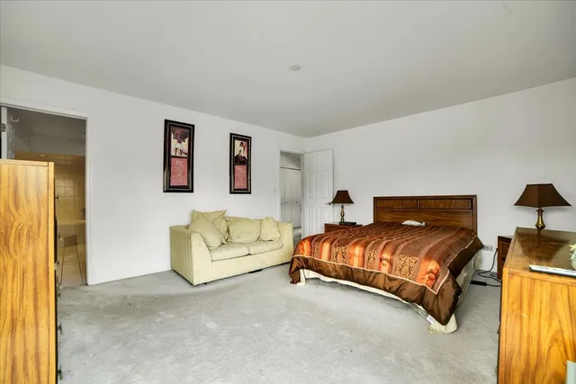 a spacious bedroom with a bed and a couch