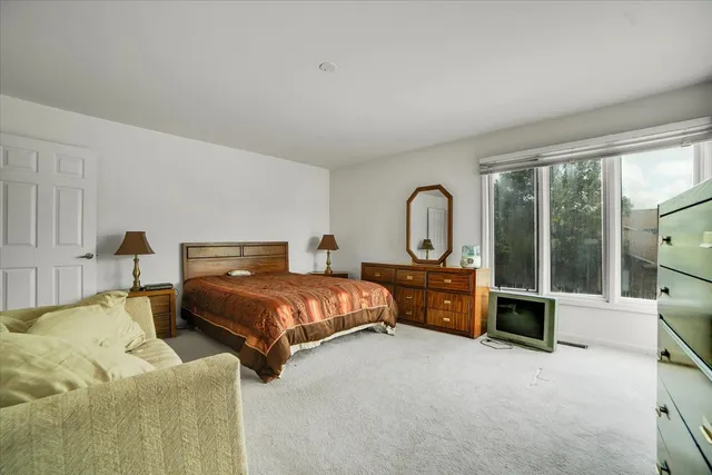 a bed room with a bed and a large window