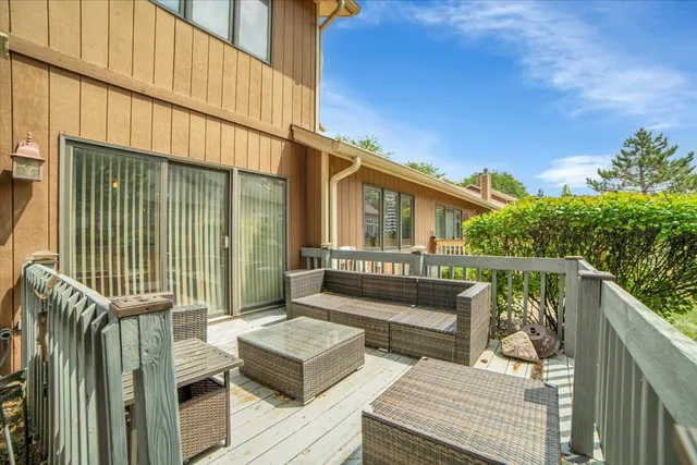 a view of balcony with wooden floor and outdoor seating