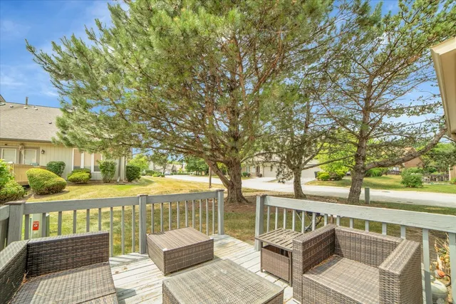 a view of a balcony with lake view and wooden floor