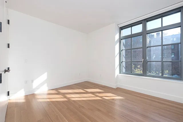 a bathroom with a granite countertop sink mirror and shower