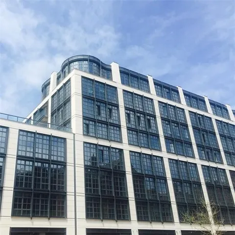 a bathroom with a granite countertop sink a toilet and a shower