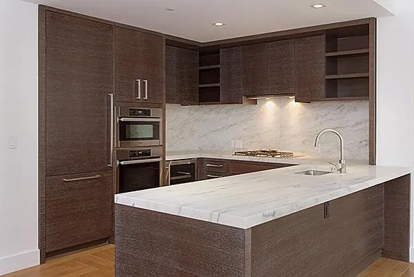 a kitchen with granite countertop wooden cabinets and stainless steel appliances