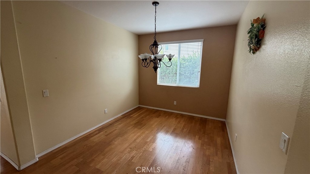 7134 Cumberland Place Rancho Cucamonga, CA 91739 - Photo 8 of 22 a view of a room with wooden floor and windows