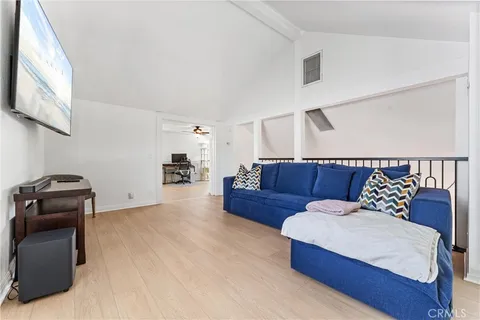 a view of a livingroom with workspace and a window