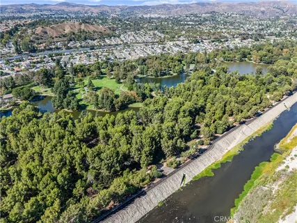 an aerial view of a house with a garden and trees