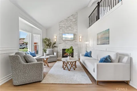 a living room with fireplace furniture and a rug