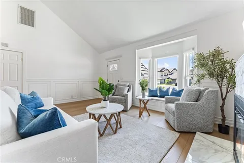 a living room with furniture and a potted plant