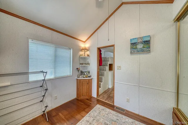 a bed sitting in a room next to a lamp