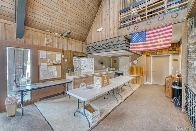 a room with gym equipment and large windows