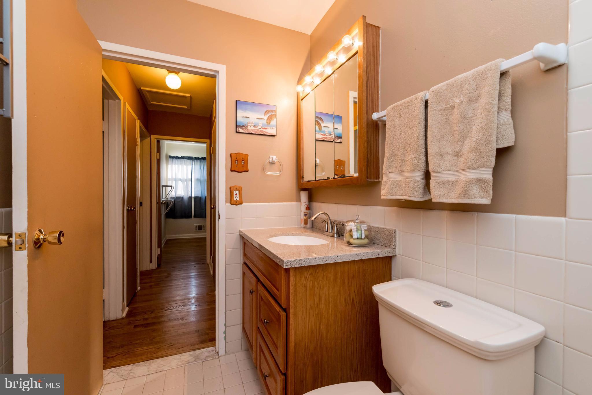810 Crosby Road Baltimore, MD 21228 - Photo 14 of 30 a bathroom with a toilet sink and mirror