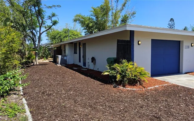 a house with a flower garden in front of it