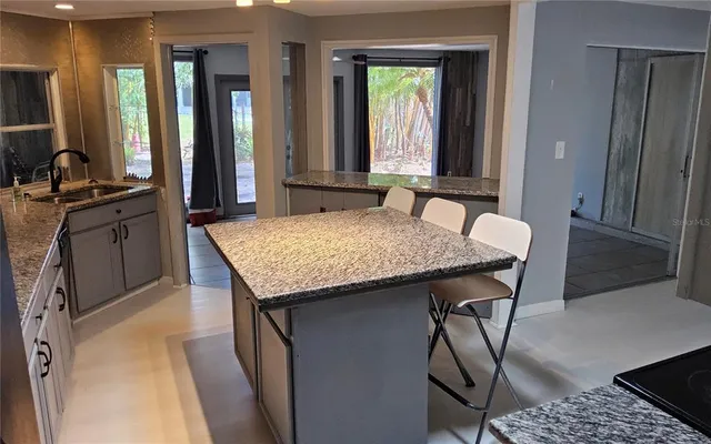 a kitchen with a table and chairs in it