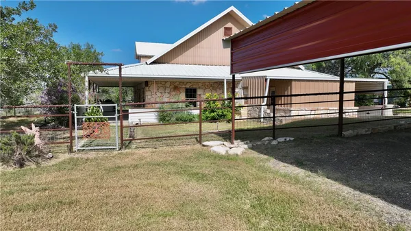 a view of backyard with sitting area