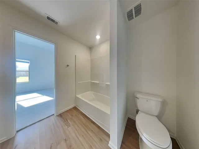 a bathroom with a toilet and a bathtub