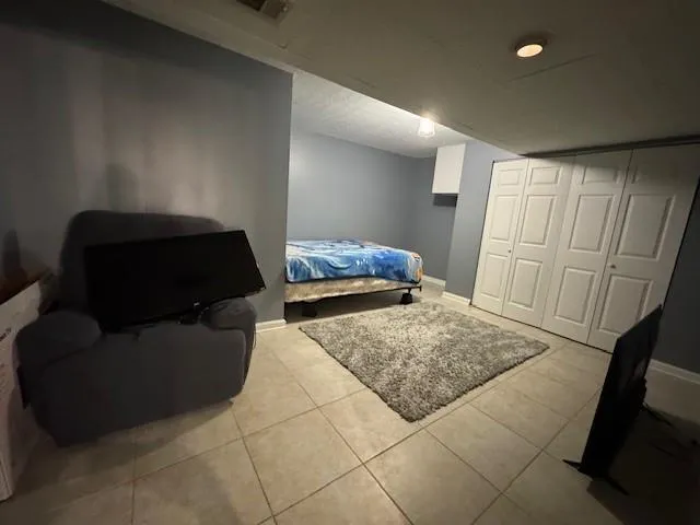 a bedroom with a bed and couch