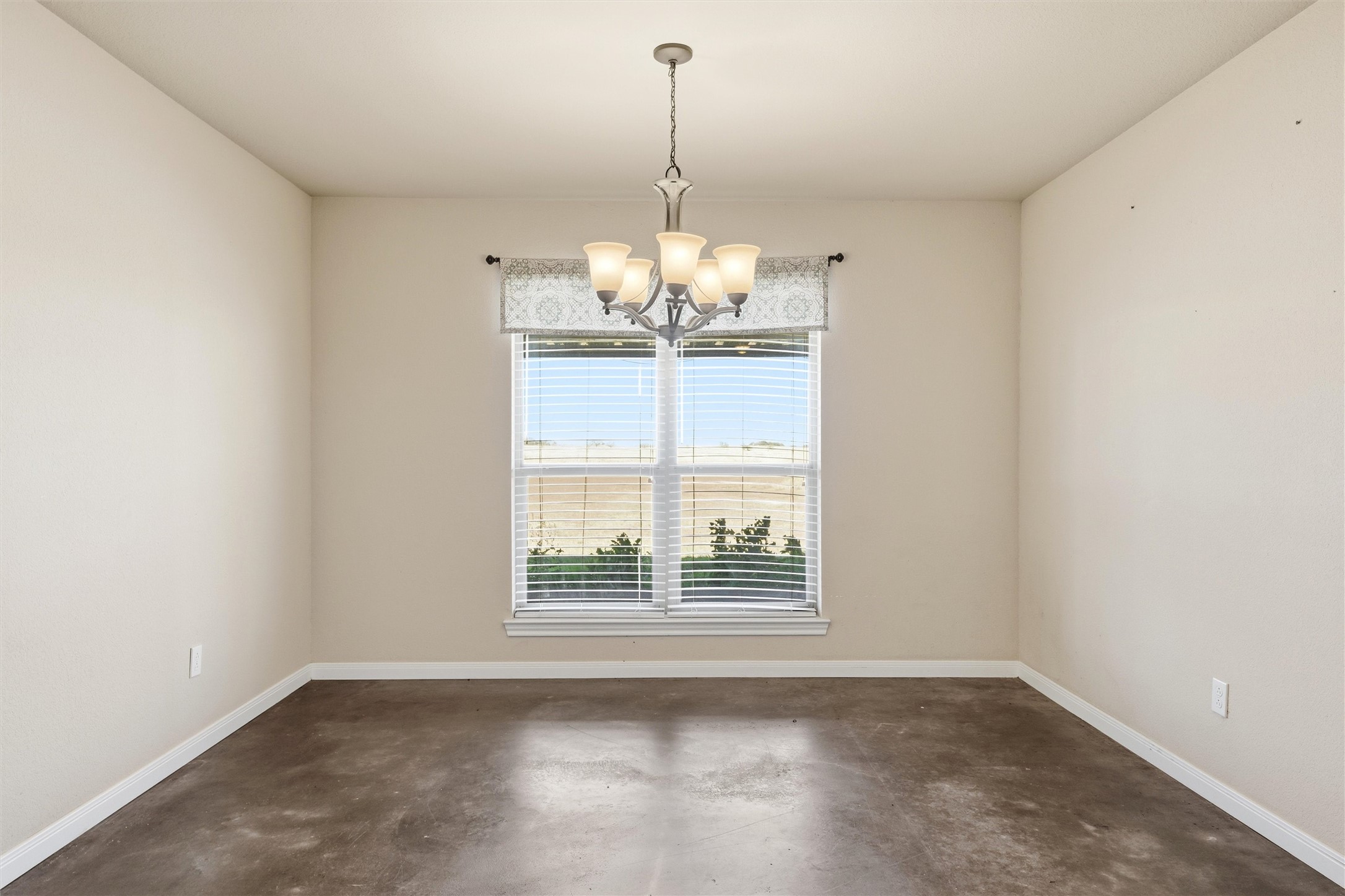 870 Patton Road Valley Mills, TX 76689 - Photo 11 of 29 an empty room with windows and chandelier