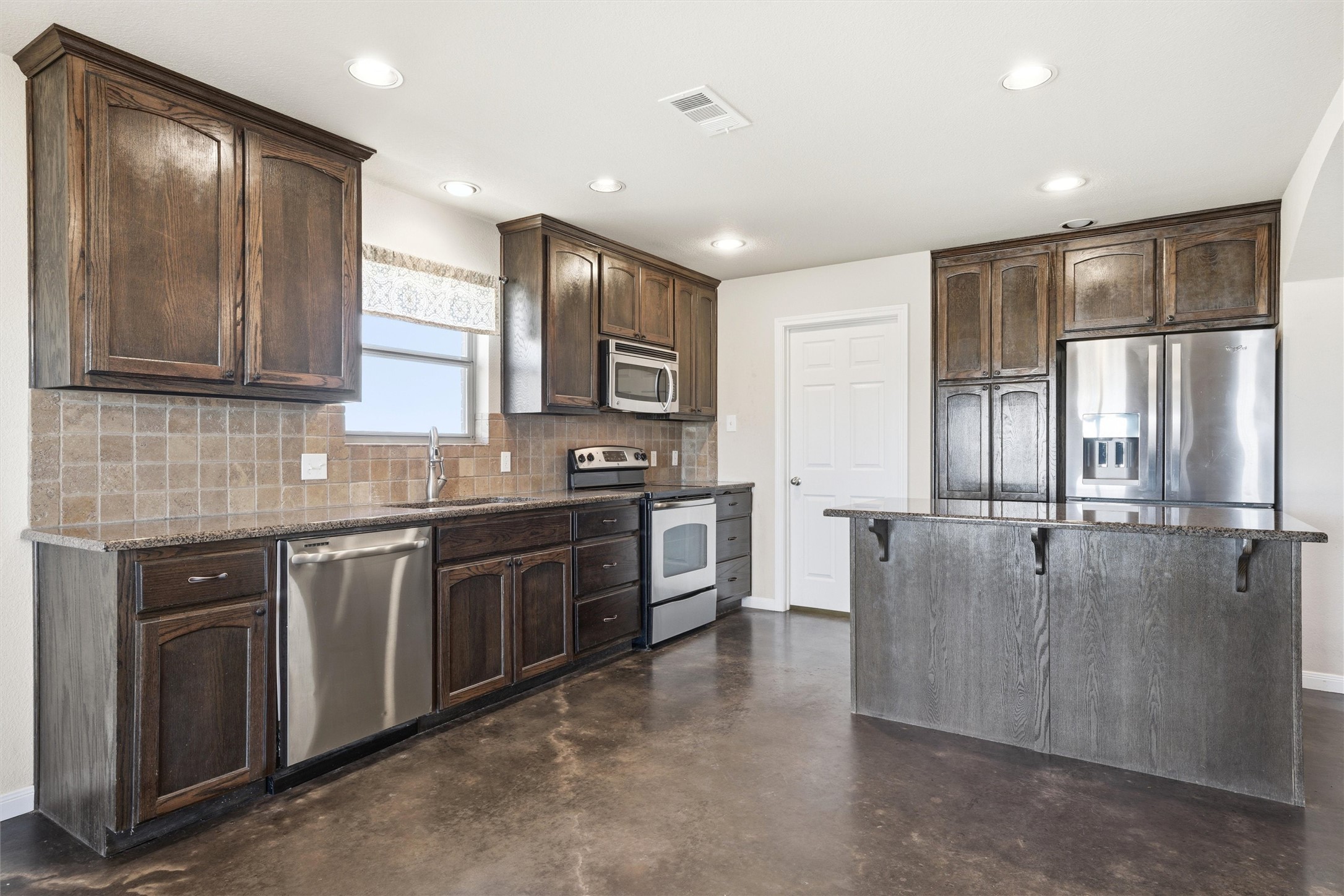 870 Patton Road Valley Mills, TX 76689 - Photo 7 of 29 a large kitchen with stainless steel appliances granite countertop a stove and a sink