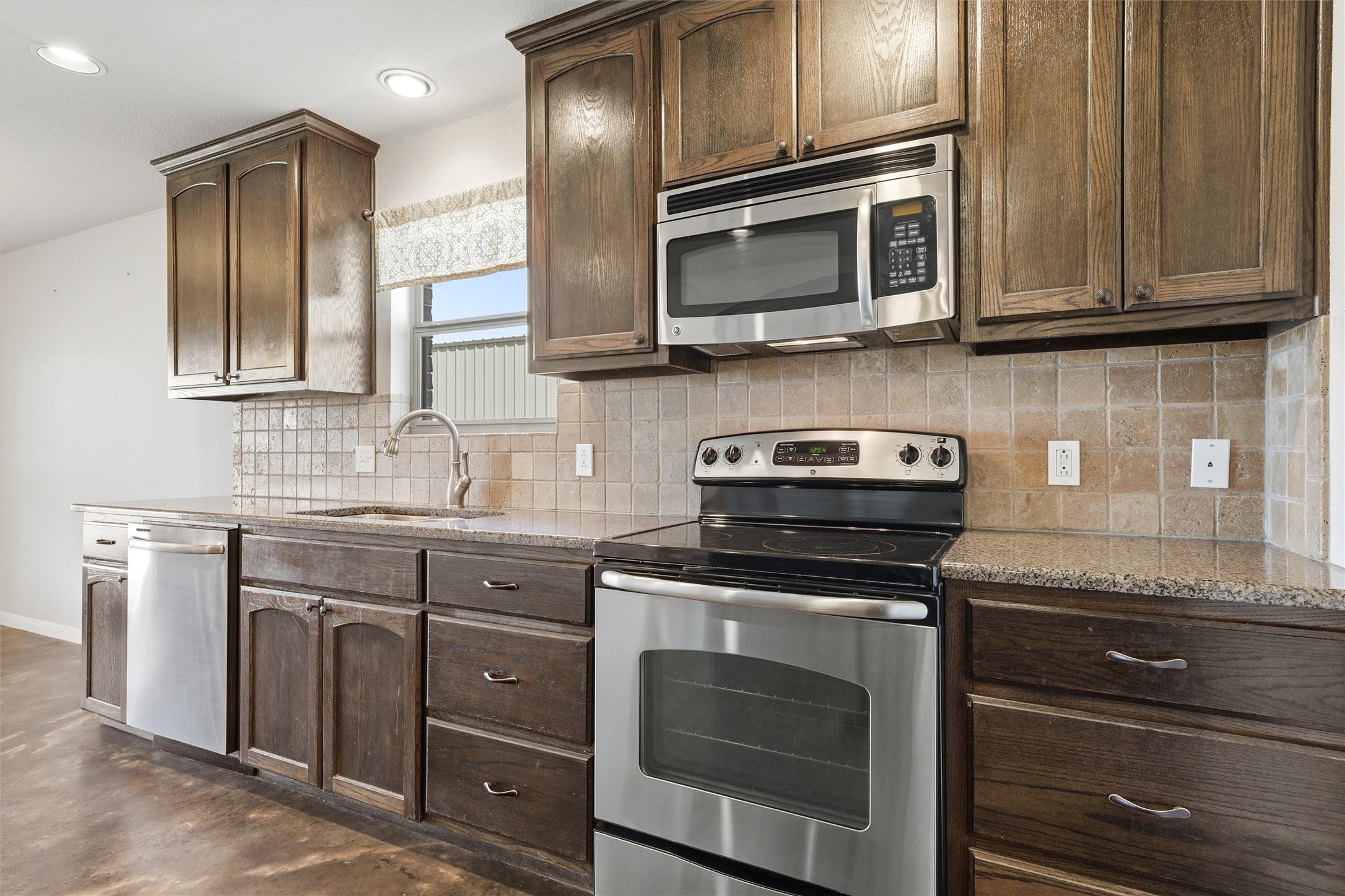 870 Patton Road Valley Mills, TX 76689 - Photo 9 of 29 a kitchen with stainless steel appliances granite countertop wooden cabinets and a stove top oven