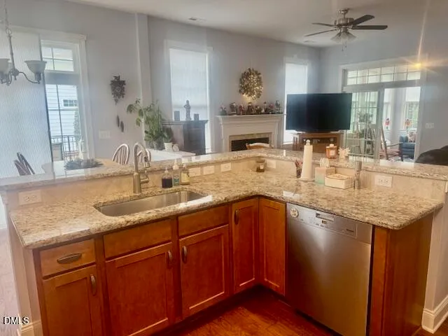 a kitchen with granite countertop a sink and a wooden floor