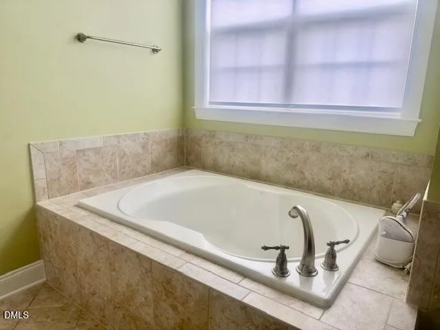 a bath tub sitting in a bathroom next to a window