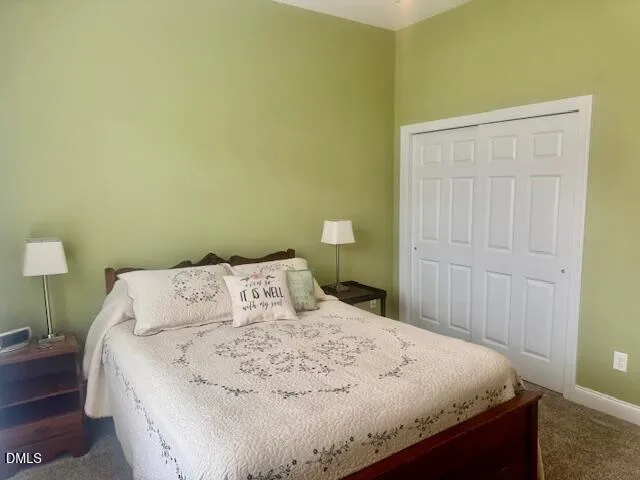 a large bed sitting in a bedroom next to a wooden cabinet