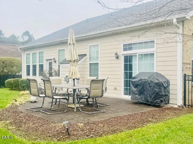 a view of a house with backyard sitting area and garden