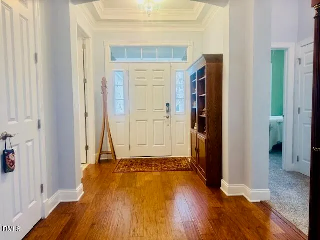 a view of a room with wooden floor and a bathroom